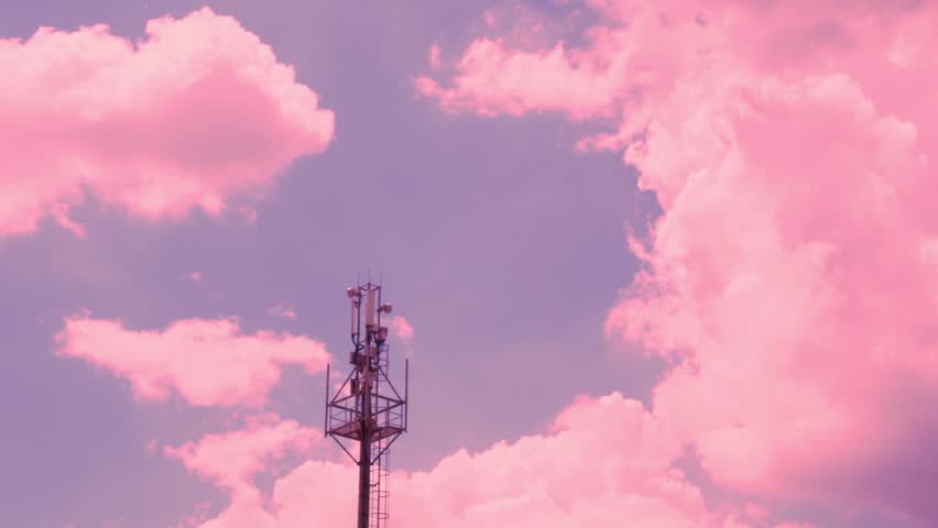 Cell Tower Close-up, 3G 4G 5G Transmitter and Beautiful Time Lapse Colorful Sunset Sky with Puffy Pink Clouds.