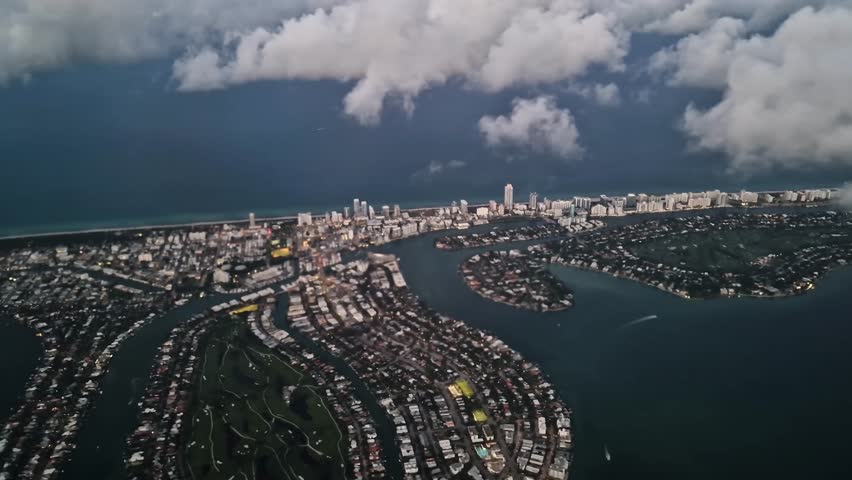 Flying Above Miami Beach and Clouds, Airplane Passenger Point of View, Florida USA