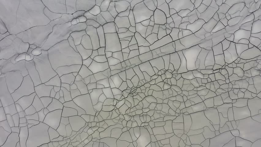  Aerial view of gray abstract mud patterns and cracks on acid mine drainage surface
