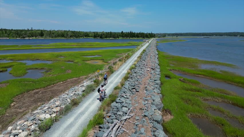 cyclist riding a bike on a path trail by the lake shore