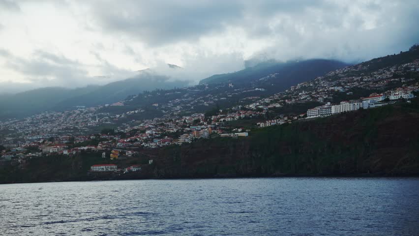 Mountain town under heavy clouds