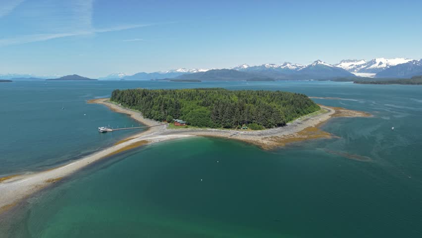 Beautiful aerial video of whale watching tour guide boat docked at a lodge at Cold Island near Juneau Alaska, USA. July 20, 2025. 