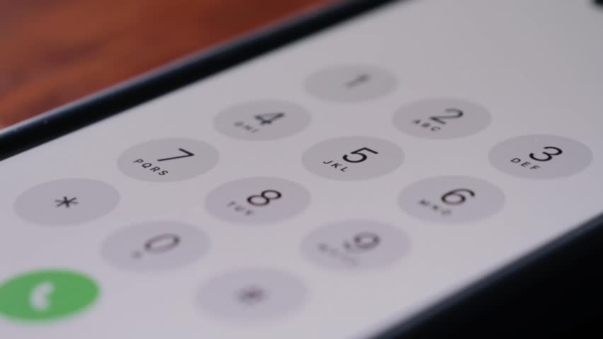 Close up of finger dialing pin or phone number on screen smartphone.