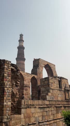 New Delhi, Delhi India – November 11, 2024: Tourists visit the historic Qutub Minar, a UNESCO World Heritage Site and iconic Mughal-era minaret built in red sandstone.