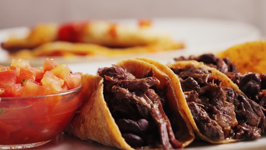 Close-up of a variation on traditional Mexican tacos made with pork and beans on corn tortillas. 