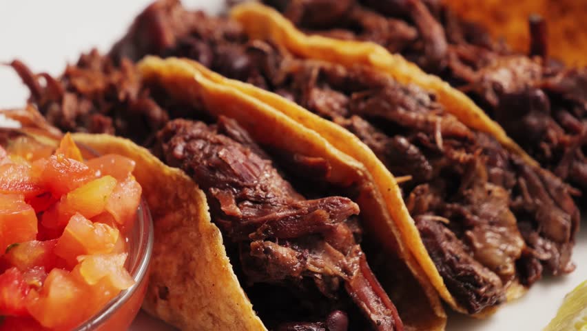 Traditional Mexican food tacos with pulled pork or beef, beans served with Mexican sauce Pico De Gallo, spicy hot sauce made from diced tomatoes, onions and jalapeno peppers.