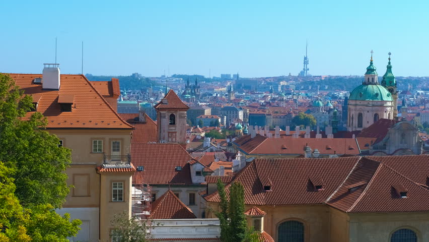 Panoramic view of prague with zizkov television tower. Red rooftops dominate the foreground, leading the eye towards the iconic zizkov television tower and the sprawling cityscape of prague