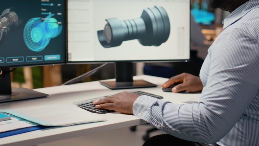 Wind energy researcher analyzes turbine component to maximize sustainability. CAD designer in office uses digital modeling software to refine blade aerodynamics, boosting clean energy output, camera B