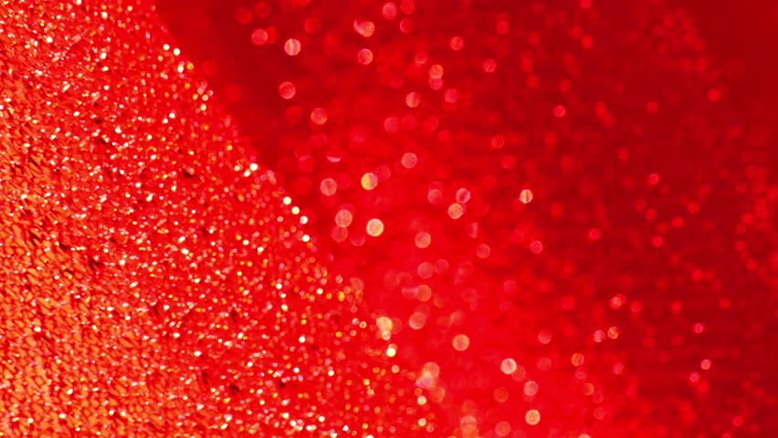 Red shiny fabric background.Christmas and New Year background. glitter macro background with shining bokeh .iridescent gradient texture.Folds of shiny fabric in red tones. 4k footage
