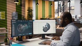 Engineer in office working on wind turbine CAD design to develop technology improving environmental performance. RD expert coming up with innovative materials for wind energy generator, camera A - Powered by Shutterstock - Get 15% off with code: PIKWIZARD15