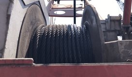Close-up of mobile crane electric drum winch. Footage of wire rope being coiled on the crane drum. Wire rope on a rotating crane. - Powered by Shutterstock - Get 15% off with code: PIKWIZARD15