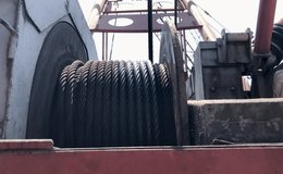 Close-up of mobile crane electric drum winch. Footage of wire rope being coiled on the crane drum. Wire rope on a rotating crane. - Powered by Shutterstock - Get 15% off with code: PIKWIZARD15