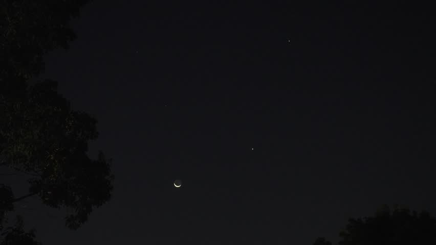 The thin moon with earthshine, Jupiter and Venus on the eastern sky at dawn.
