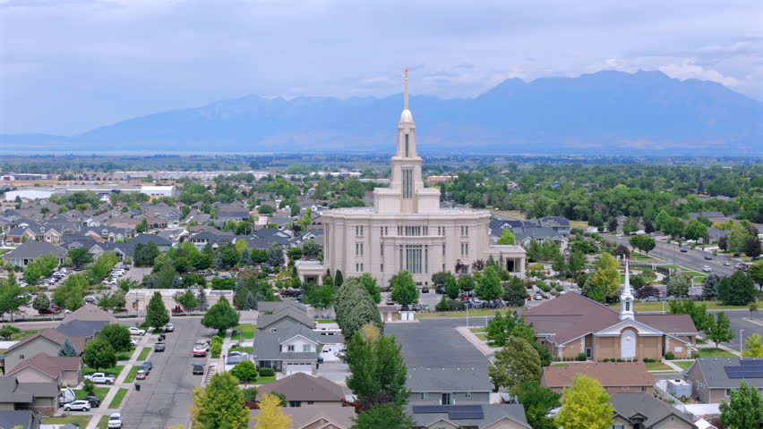 Aerial footage showcases the grandeur of the Payson Utah Mormon Temple, highlighting its unique architecture amidst the serene rural landscape, enhancing its beauty and significance