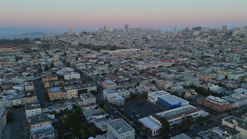 Stunning aerial shot beautifully captures the vibrant residential areas of San Francisco during the enchanting sunset, showcasing the citys iconic skyline in all its glory and charm