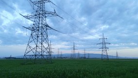 Panoramic view of an expansive electrical grid with tall pylons over a verdant field under a dramatic sky, showcasing sustainable energy infrastructure blending nature and modern power transmission. - Powered by Shutterstock - Get 15% off with code: PIKWIZARD15
