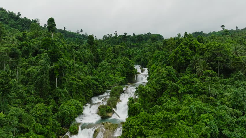 Move forward view of Aliwagwag Falls. Beautiful waters flowing over the rocks. Mindanao, Philippines.