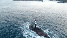 aerial footage captures a solitary lighthouse amidst the powerful waves of the Atlantic Ocean, near the iconic Atlantic Ocean Road in Norway. - Powered by Shutterstock - Get 15% off with code: PIKWIZARD15