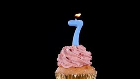 Blue number seven candle blown out on strawberry cupcake, smoke swirling under dramatic studio lighting. - Powered by Shutterstock - Get 15% off with code: PIKWIZARD15