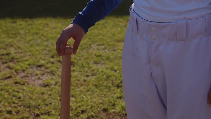 Medium Shot of a Baseball Player Twirling a Baseball Bat on Field in 4K Ultra HD
