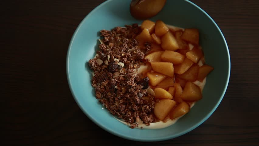 healthy autumn breakfast bowl yogurt granola and apple close up