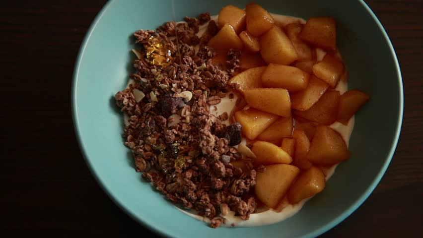 healthy autumn breakfast bowl yogurt granola and apple close up
