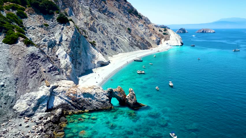 Aerial view of the beautiful Lalaria beach at Skiathos Island, Sporades, Greece, with the natural rock arch and turquoise shining sea