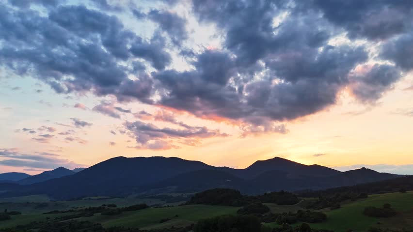 Timelapse of sunset over mountain peaks near Dolny Kubin in the Orava region of Slovakia. Warm light and drifting clouds in the Zilina region. Perfect for nature, travel, and cinematic visuals