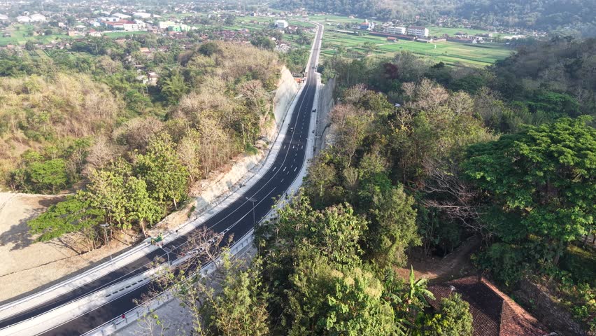 Aerial view, the new road that cuts through the hills from the city of Jogja to Gunungkidul passing the Banyunibo cliff climb.