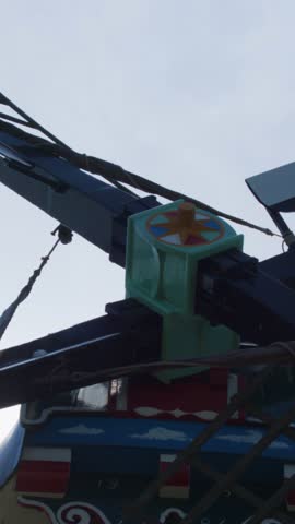Close-up of traditional windmill blades rotating under overcast sky, steady camera, natural daylight