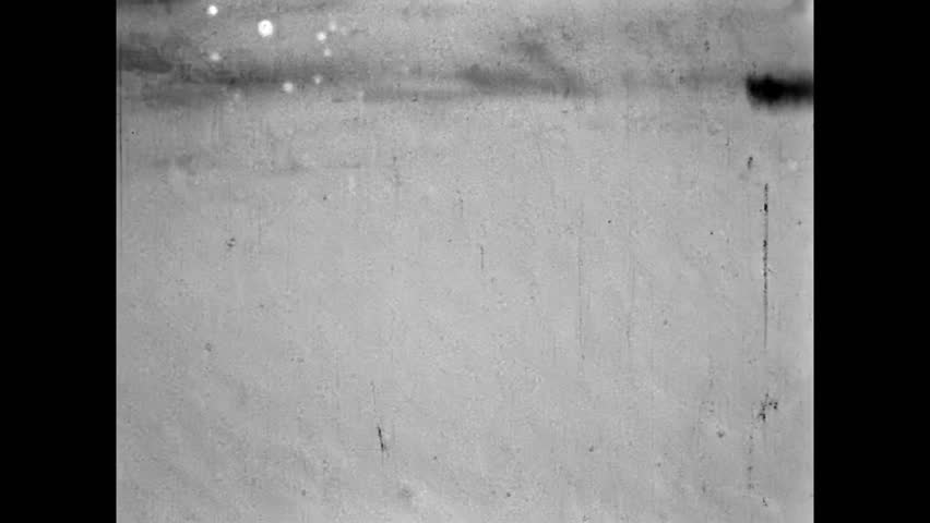 Old film, Man skiing down by snowy mountain piste in forest. Winter sport activity, travel adventure. Ski tourism in snow vacation. Nostalgic holiday recreation. Vintage archive. Archival retro 1960s