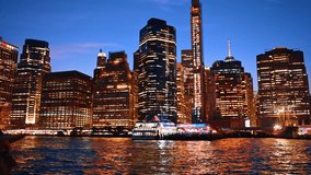 Varied high-rise buildings in the luminous skyline of New York. Boat tour along the stunning waterfront at night. - Powered by Shutterstock - Get 15% off with code: PIKWIZARD15