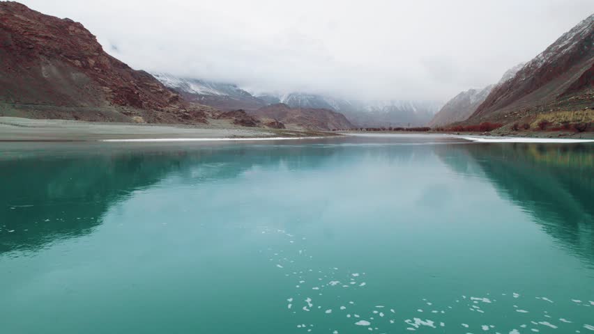 Beautiful drone view of lake in Gilgit Baltistan, Pakistan. Beautiful lake, blue water, rock mountains, trees, travelling, nature, spa, beauty, Northern area of Pakistan, beautiful valley.