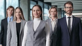 A group of people dressed in business attire stand together in a room - Powered by Shutterstock - Get 15% off with code: PIKWIZARD15