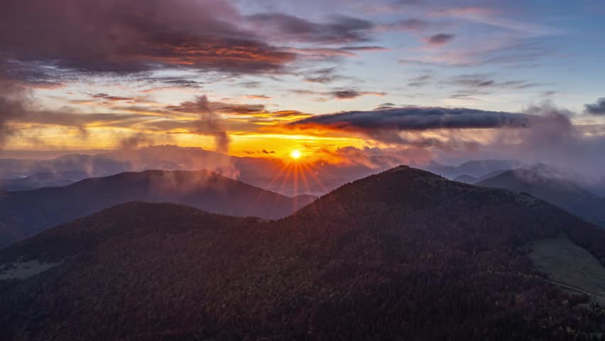 Golden Sunrise Over Mountains with Fast Moving Clouds, Nature Timelapse