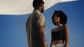 African American man embracing his girlfriend on rooftop date, showing affection - Powered by Shutterstock - Get 15% off with code: PIKWIZARD15