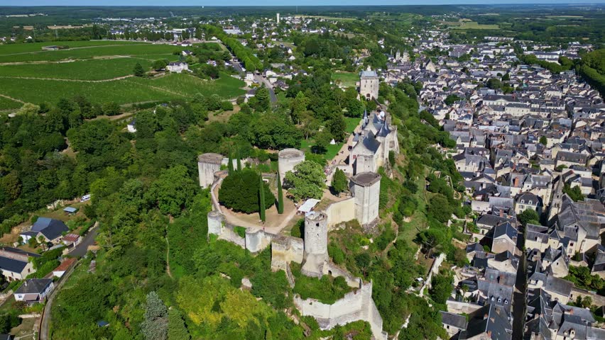 Panoramic drone fly around the medieval castle of Forteresse Royale de Chinon within a French riverside, Chinon, Indre-et-Loire, France.