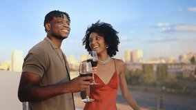 Happy African American couple drinking wine and enjoying their rooftop date - Powered by Shutterstock - Get 15% off with code: PIKWIZARD15