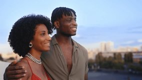 Young African American couple enjoying beautiful cityscape during rooftop date - Powered by Shutterstock - Get 15% off with code: PIKWIZARD15