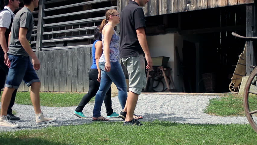Shot of a group of young people visiting an old but very preserved farm