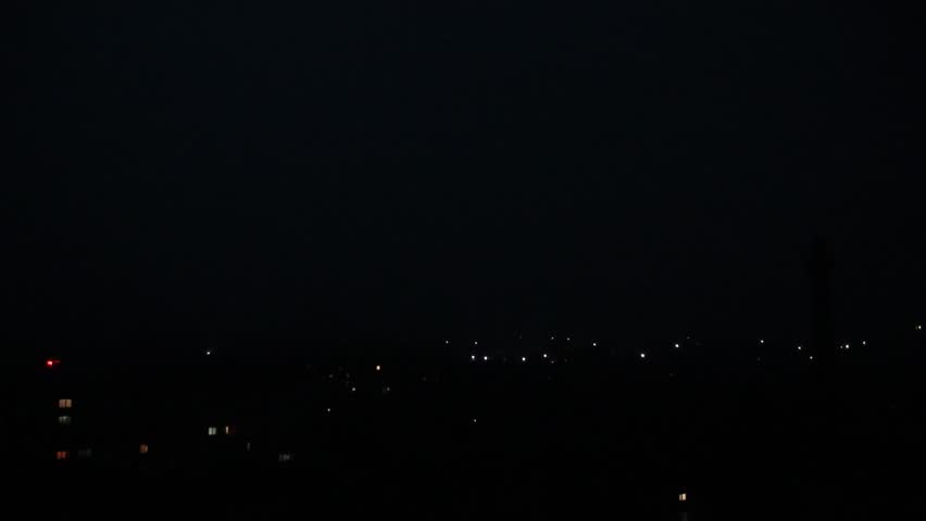 Slow Motion Lightning Strike Over a City. A Purple Sky at Night. A City at Night. Peaceful Slow Motion Lightning and a Purple Sky.