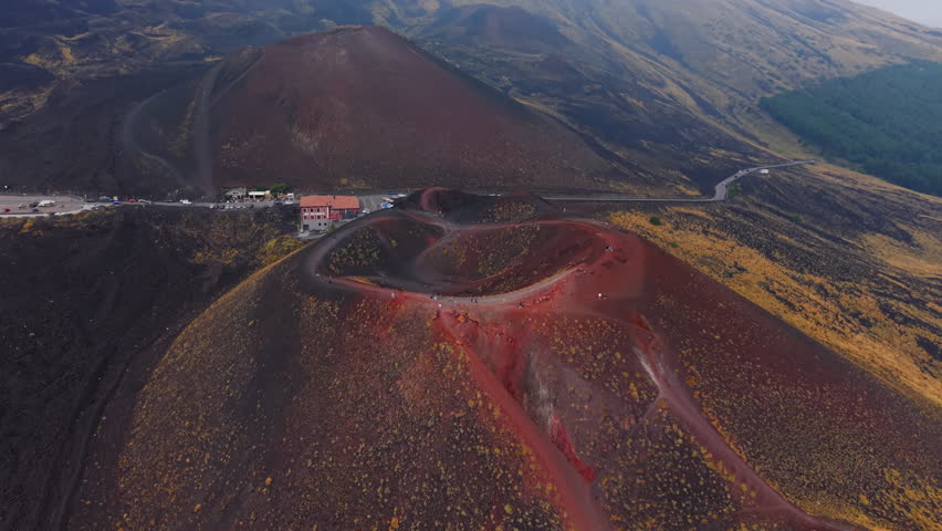 Aerial view of Etna's red crater in Sicily, showcasing rugged landscape