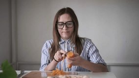 Woman peeling carrot at kitchen table, meal preparation, home cooking, healthy lifestyle - Powered by Shutterstock - Get 15% off with code: PIKWIZARD15