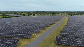 Aerial drone cinematic footage of solar farm and wind turbines producing clean renewable energy in rural landscape Yelvertoft Lutterworth UK - Powered by Shutterstock - Get 15% off with code: PIKWIZARD15
