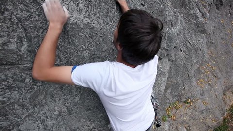 Young man rock climbing in nature Stock Video