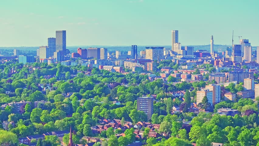Birmingham city skyline and iconic landmarks towering over the vibrant greenery of Cannon Hill Park in summer, providing a sweeping vista of the city and its natural surroundings