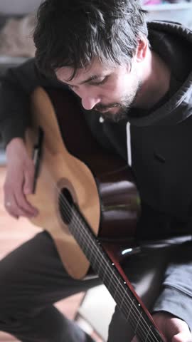 Man playing acoustic guitar at home, music hobby, creative leisure, inspiration, lifestyle, learning