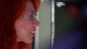 Close-up of female developer smiling at computer screen with code. Modern office scene highlights programmer skills, coding, software, technology, data, and cyber-focused development work. 4k video - Powered by Shutterstock - Get 15% off with code: PIKWIZARD15