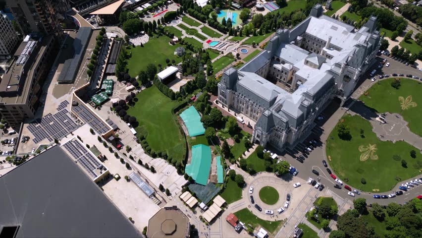 Aerial drone footage of the Iasi cultural palace in the city of Iasi in Romania at night. Beautiful palace of culture in moldavia. High angle flyover shot of sunny urban cityscape from above.