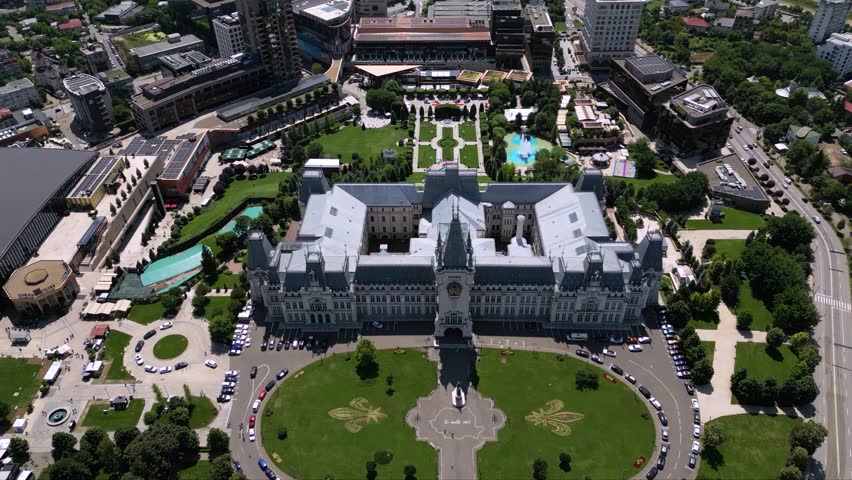 Aerial drone footage of the Iasi cultural palace in the city of Iasi in Romania at night. Beautiful palace of culture in moldavia. High angle flyover shot of sunny urban cityscape from above.